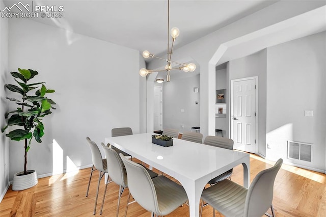 dining room with a chandelier and light hardwood / wood-style floors