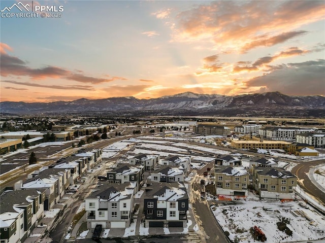 snowy aerial view featuring a mountain view