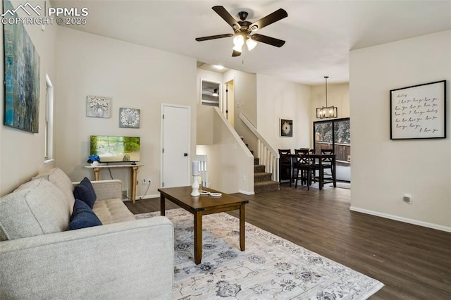 living room featuring hardwood / wood-style floors and ceiling fan with notable chandelier