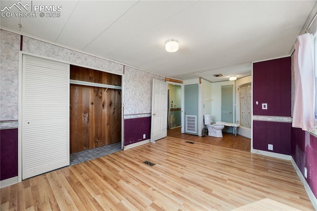 unfurnished bedroom with hardwood / wood-style flooring