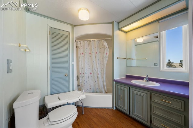 full bathroom with hardwood / wood-style flooring, vanity, toilet, and shower / bath combination with curtain