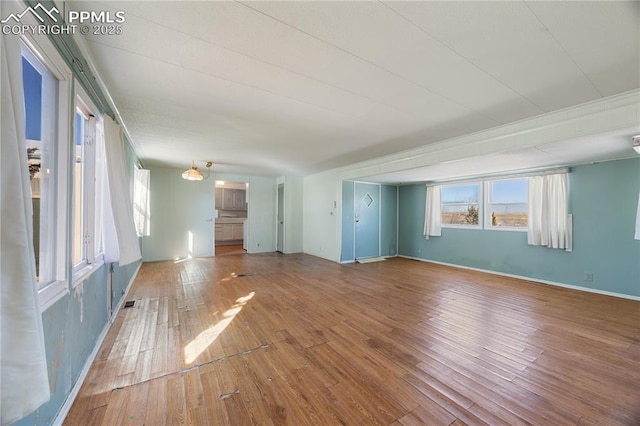 unfurnished living room with hardwood / wood-style flooring