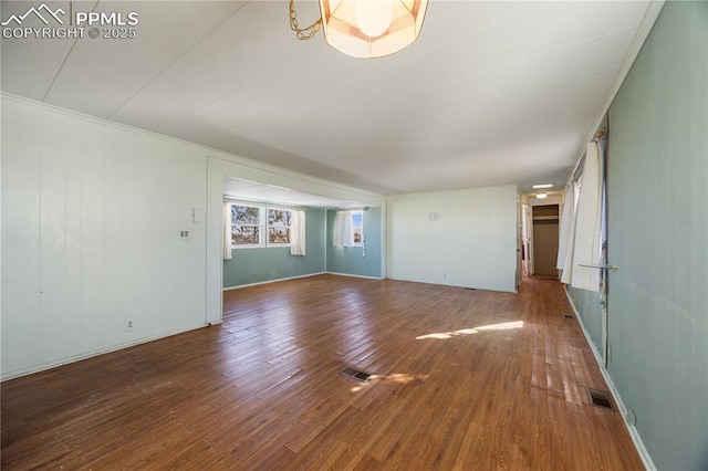 unfurnished living room featuring wood-type flooring