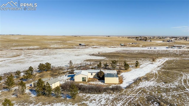 snowy aerial view featuring a rural view