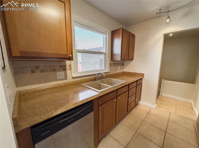 kitchen with sink, decorative backsplash, stainless steel dishwasher, and light tile patterned floors