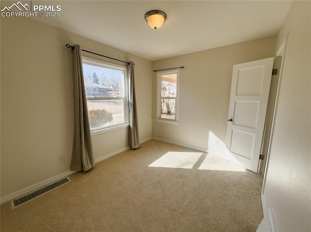 empty room featuring light colored carpet