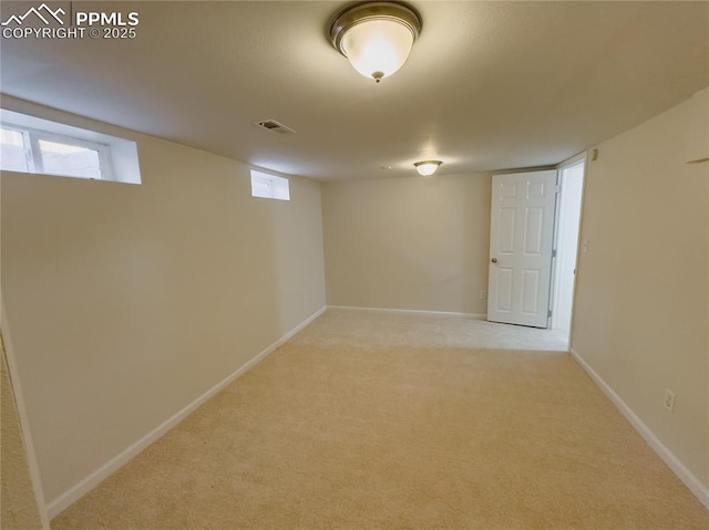 basement featuring light colored carpet