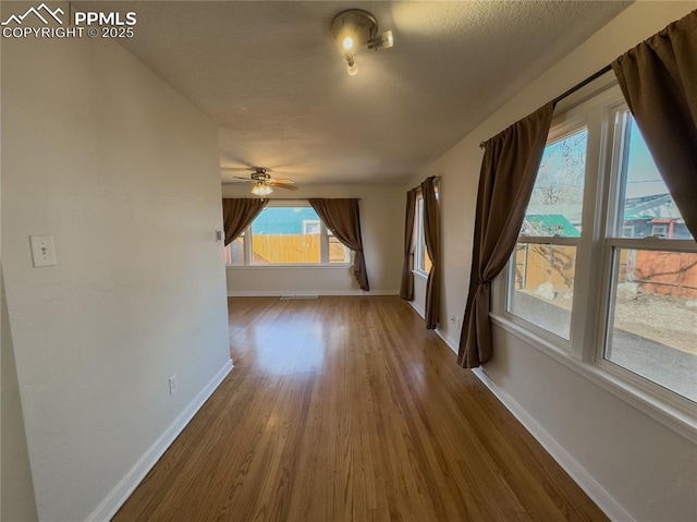 bonus room with hardwood / wood-style flooring, a textured ceiling, and ceiling fan