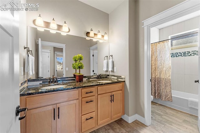 full bathroom with hardwood / wood-style flooring, vanity, shower / bath combo, and toilet