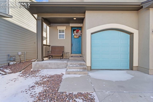 view of snow covered property entrance