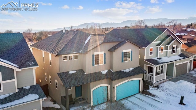 view of front facade featuring a garage and a mountain view