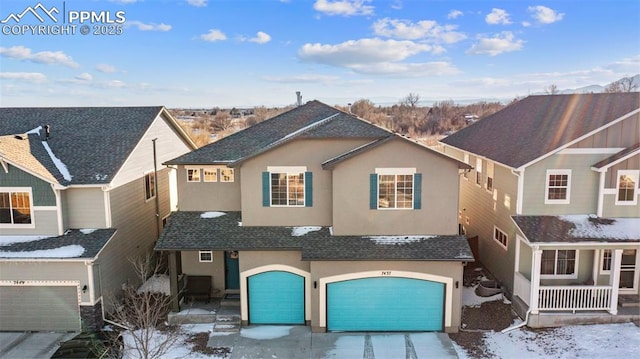 view of property featuring a garage and covered porch