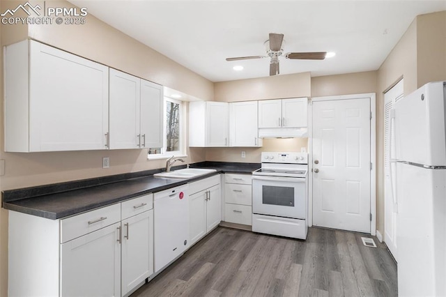 kitchen featuring hardwood / wood-style flooring, white appliances, sink, and white cabinets