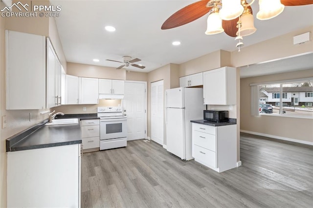 kitchen with sink, white appliances, light hardwood / wood-style floors, and white cabinets