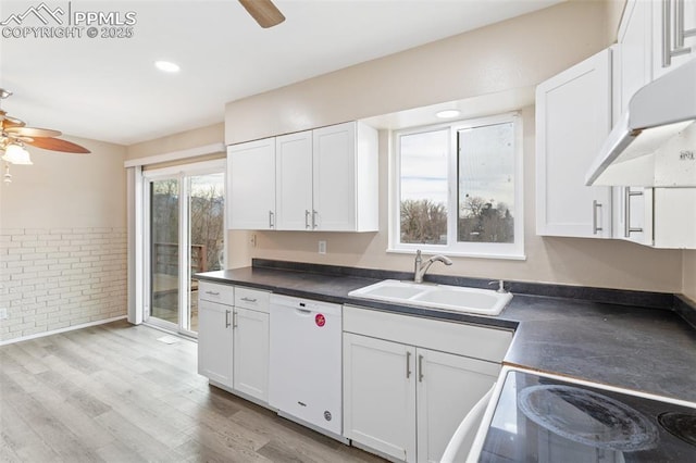 kitchen featuring white dishwasher, sink, white cabinets, and ceiling fan