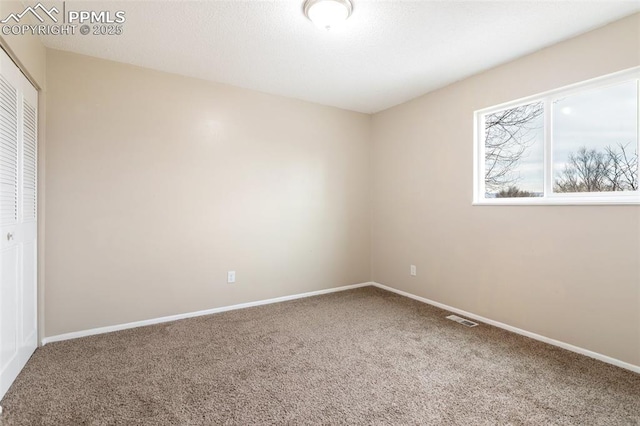 empty room with carpet flooring