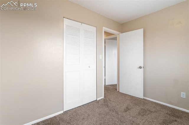 unfurnished bedroom featuring a closet and carpet