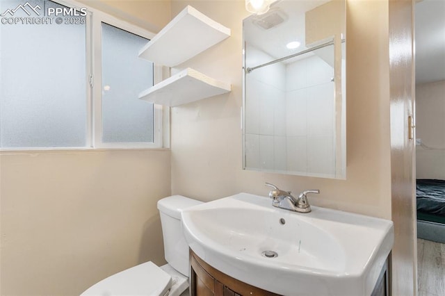 bathroom featuring vanity and toilet