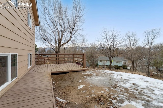 snowy yard with a deck