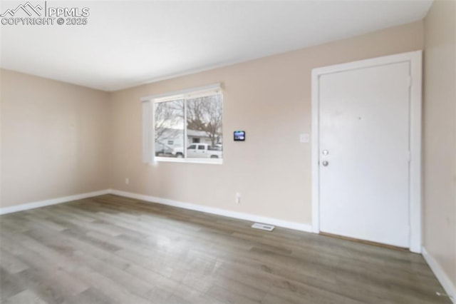 empty room featuring wood-type flooring