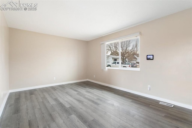 spare room with hardwood / wood-style floors