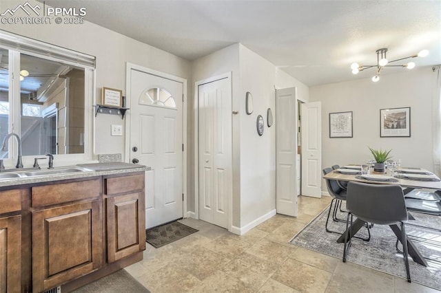 bathroom with an inviting chandelier and vanity