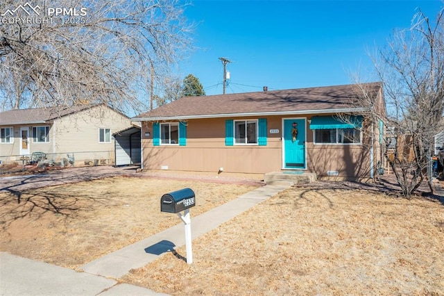 view of front facade with a front yard and a carport