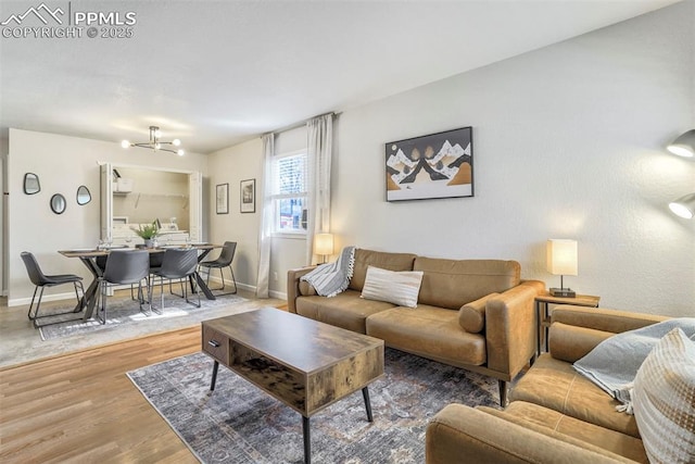 living room featuring hardwood / wood-style flooring and a chandelier