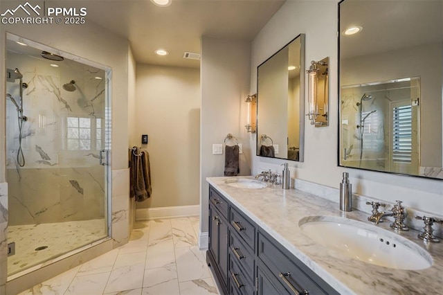 bathroom with marble finish floor, a marble finish shower, baseboards, and a sink