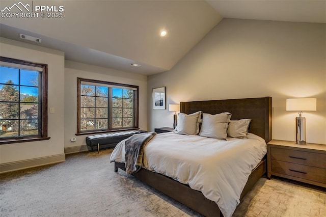 bedroom featuring vaulted ceiling, multiple windows, visible vents, and baseboards