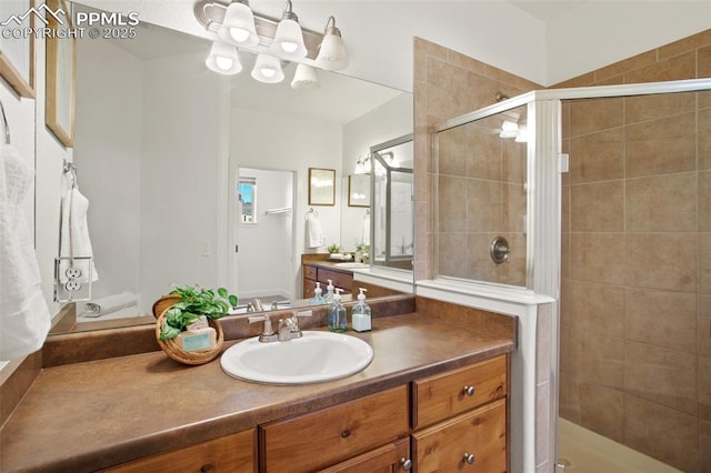 bathroom featuring vanity and a shower with door