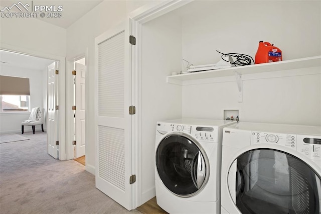 clothes washing area featuring light colored carpet and washing machine and dryer