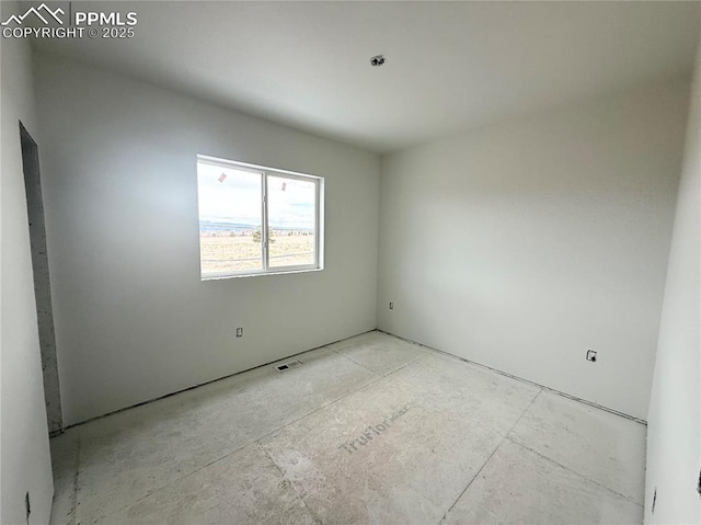 unfurnished room featuring visible vents