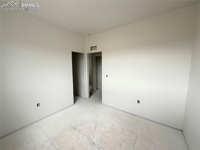 empty room with concrete flooring