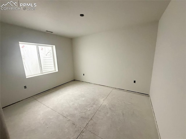 spare room with concrete floors