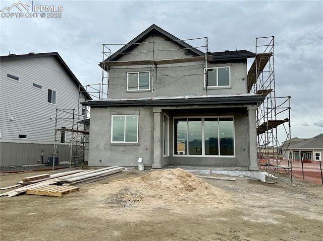 back of house with stucco siding