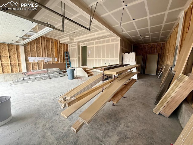 miscellaneous room with a garage and concrete floors