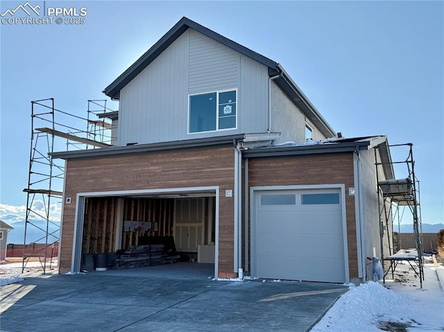 view of property exterior with a garage and concrete driveway