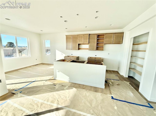 kitchen featuring recessed lighting, a center island, baseboards, and open shelves