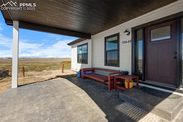 entrance to property with a rural view