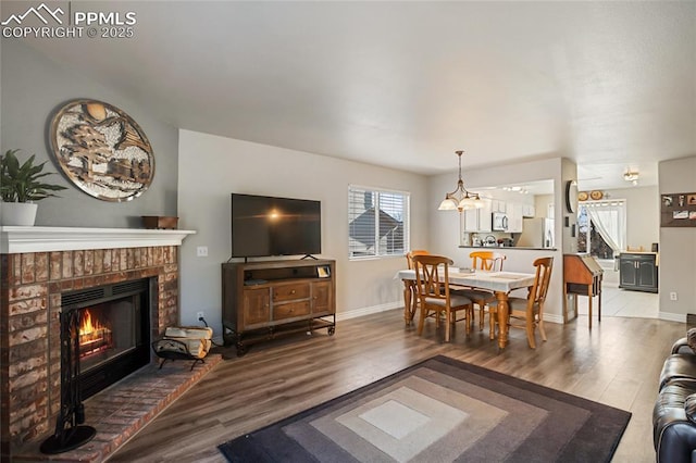 living room with hardwood / wood-style flooring and a fireplace