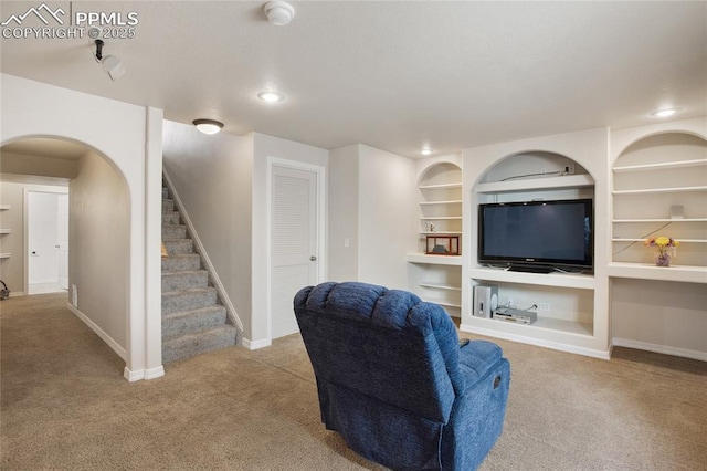 carpeted living room with built in shelves