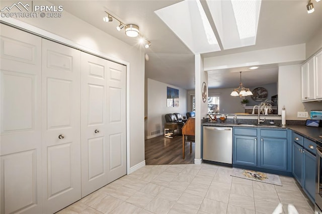 kitchen with sink, blue cabinetry, decorative light fixtures, stainless steel dishwasher, and a chandelier