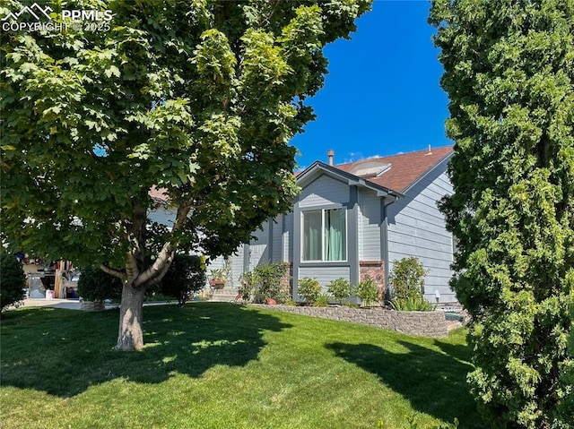 view of side of home featuring a yard