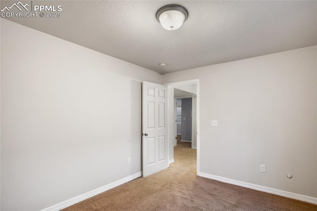 unfurnished room featuring carpet floors and a textured ceiling