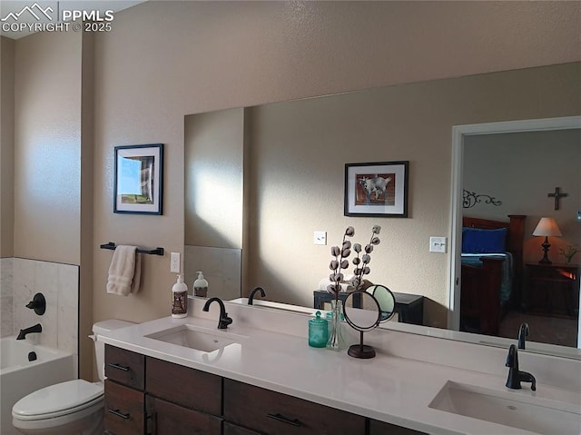 bathroom with vanity, a bathtub, and toilet