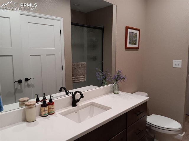 bathroom with vanity, toilet, and walk in shower