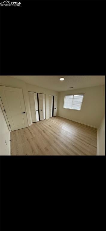 additional living space with light hardwood / wood-style floors