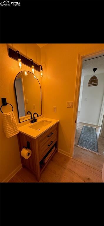 bathroom featuring hardwood / wood-style flooring and vanity