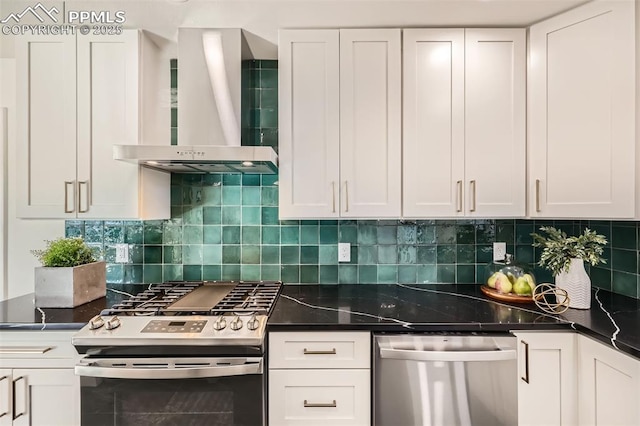 kitchen with stainless steel appliances, wall chimney range hood, white cabinets, and decorative backsplash